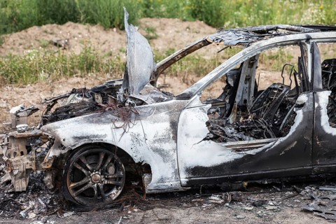 Road wreck accident or arson fire burnt wheel car vehicle junk