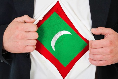 The Maldives flag painted on the chest of a man