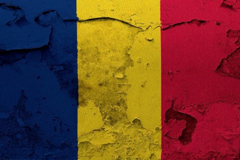 Chad flag painted on the cracked grunge concrete wall
