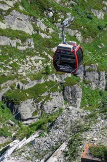 Cabin of cable car Hospizbahn travelling over mountainous alpine terrain to Grimsel Hospiz