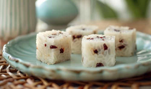 Chinese sweet rice cakes with red bean on a pastel green plate AI generated