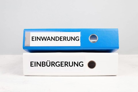 Naturalization and immigration is standing in german language on the folders, new reform immigrants