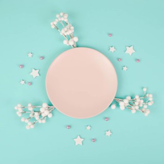 Empty plate, snow covered berries, rose colored baubles, christmas holiday and new year, festive