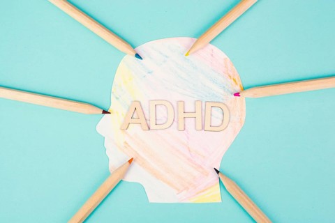 ADHD standing on a colorful head with pencils, attention deficit hyperactivity disorder, mental