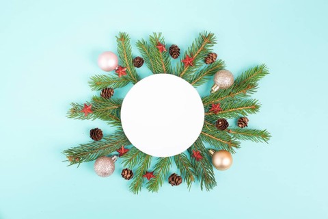 Christmas holiday background, frame with fir branches, baubles, candy cane and cones, winter season