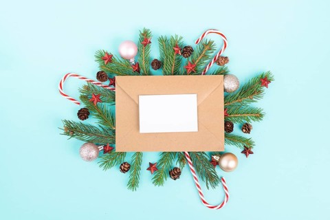 Christmas holiday background, frame with fir branches, baubles, candy cane and cones, winter season