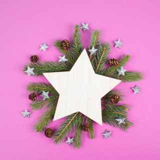 Christmas holiday background with a star, frame with fir branches and pine cones, winter season