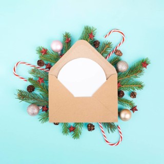 Christmas holiday background, enveloep with fir branches, baubles, candy cane and cones, winter