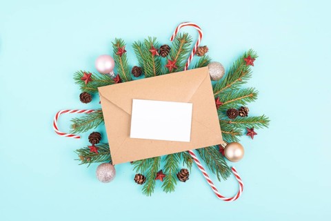 Christmas holiday background, frame with fir branches, baubles, candy cane and cones, winter season