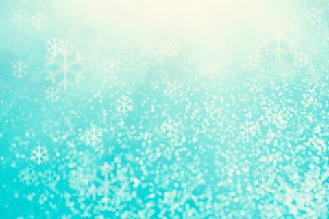 Blue bokeh background with snowflakes for christmas, defocused round lights and sunbeams, flare