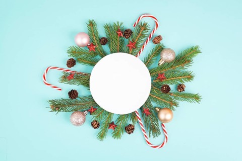 Christmas holiday background, frame with fir branches, baubles, candy cane and cones, winter season