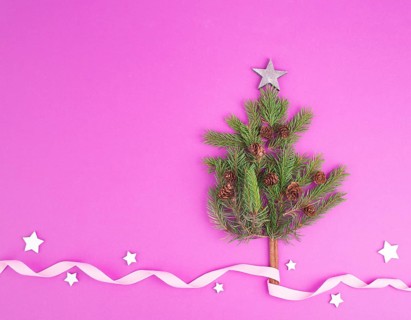 Christmas tree made from fir branches, pine conesba and a cinnamon stick as the trunk, pink