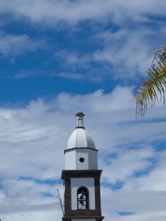 Close-up of a bell tower under a sky with scattered clouds, arrecife, Lanzarote, Canary Islands,