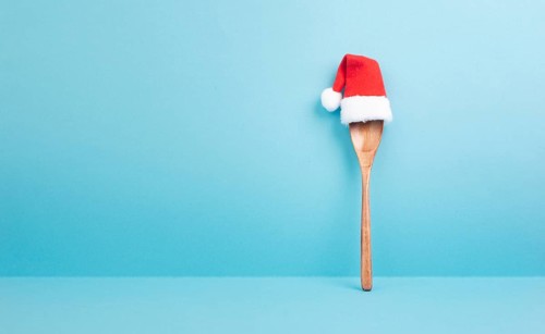 Blank paper with a wooden spoon and a red Santa Claus hat, christmas greeting card, copy space for