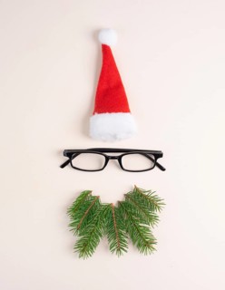 Christmas season, Santa Claus face with a red hat, eyeglasses, beard made from fir twigs,