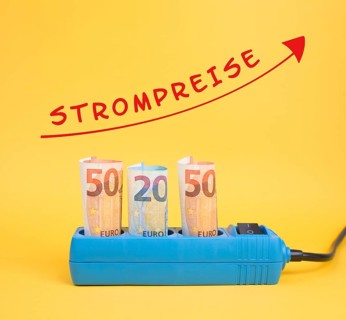 Euro banknotes in a power outlet, increasing prices for electricity is standing in german language