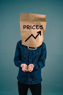 Young man with paper bag on his head, increasing prices, open hands begging for money, finacial
