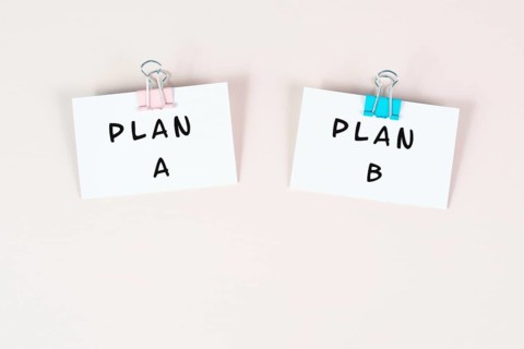 Plan A and B standing on paper, brainstorming for possibilities, making a decision