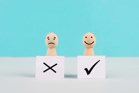 Men holding signs with a check mark and a cross, business and education concept, happy and sad