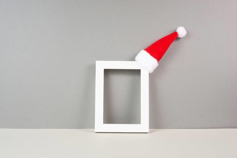 Home interior poster mock up with wooden frame, a red Santa Claus hat, greeting card for christmas,