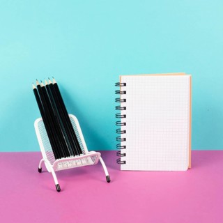 Empty notebook with pencils in a chair, being creative and brainstorming for new ideas, writing a
