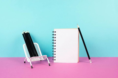 Empty notebook with pencils in a chair, being creative and brainstorming for new ideas, writing a