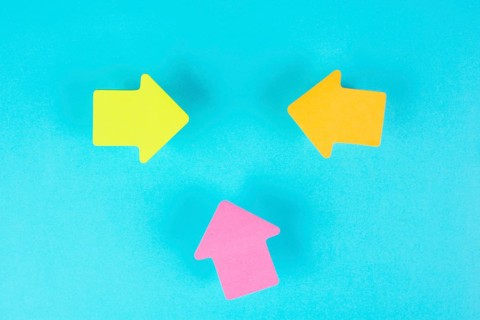 Arrows pointing to the middle with copy space, having a taget, planning a strategy for business