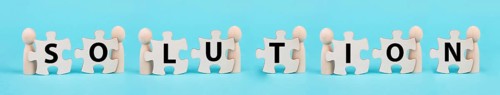 The word solution is standing on puzzle pieces, working as a team together to reach a goal,