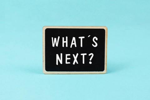 The phrase whatÂ´s next is standing on a chalkboard, having new goals and strategies, making plans