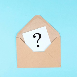 Question mark on a paper in an envelope, education and business concept, searching for answers,