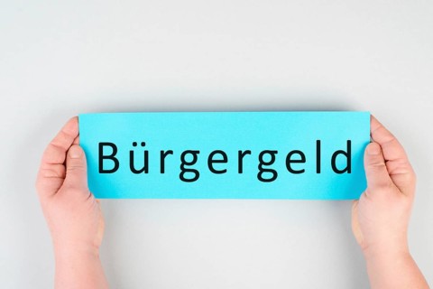 The german word for citizen money is standing on a paper, new financial help system for