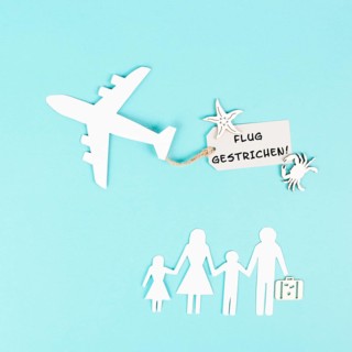 The words flight canceled are standing in german language on the sign of the airplane, staff