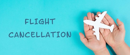 Holding an airplane in the hands, flight cancellation is standing on the paper, staff shortage at