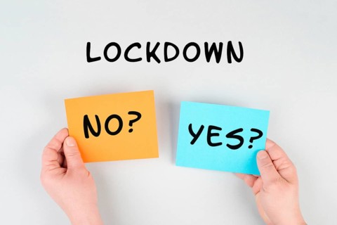 The words lockdown yes or no are standing on a paper, Covid-19 and monkeypox pandemic regulations,