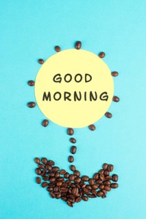 Flower made with coffee beans, the words good morning are standing on the blossom, wake up, having