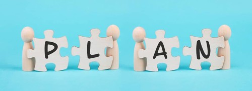 The word plan is standing on puzzle pieces, connect the parts together, corporate in teamwork,