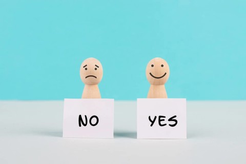 Men holding signs with the words yes and no, communication between people, business and education