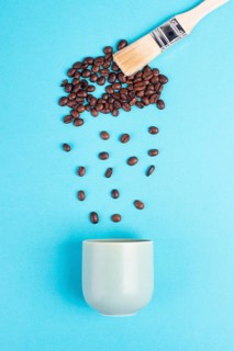 Brush paints cloud with roasted coffee beans raining into a cup, take a break, having an espresso
