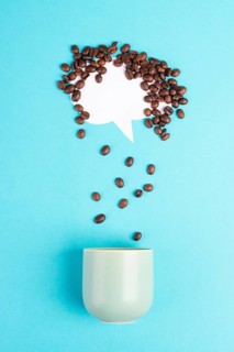 Cloud with roasted coffee beans raining into a cup, take a break, having an espresso for breakfast
