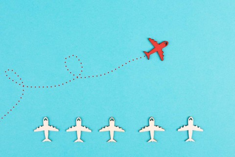 Red airplanes takes a different direction, leadership and business concept, follow your dreams,
