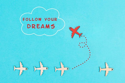 Red airplanes takes a different direction, flying to the cloud with the phrase follow your dreams,