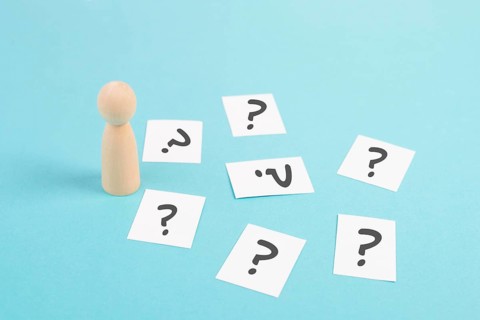 Man is thinking, question marks, brainstorming and looking for answers, solving a problem, making a