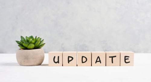 The words update is standing on wooden cubes, progress in business, desk in an office, copy space