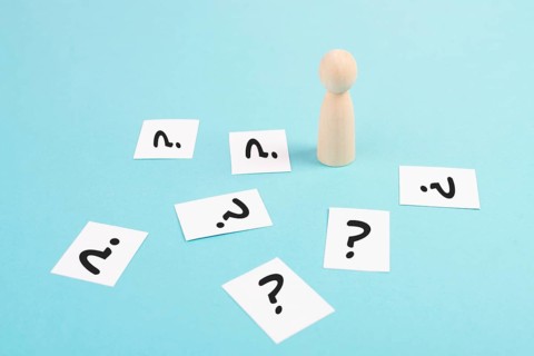 Man is thinking, question marks, brainstorming and looking for answers, solving a problem, making a