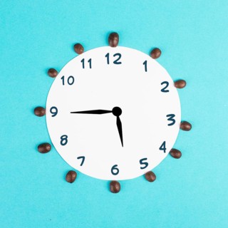 Alarm clock with numbers and coffee beans, wake up in the morning, having a deadline, time for a