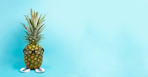 Pineapple with glasses and flip flops, vacation and travel concept, tropical summer holiday, funny