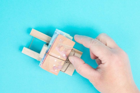 Euro banknotes in a mousetrap, bank loan, finanicial debt, inflation, risky credit and investment,