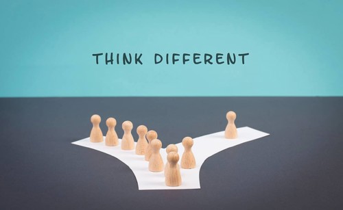 Think different stands on the blue background, one nonconformist is standing out from the crowd,
