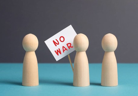 Group of protesters holding a sign with the words no war, demonstration for human right and