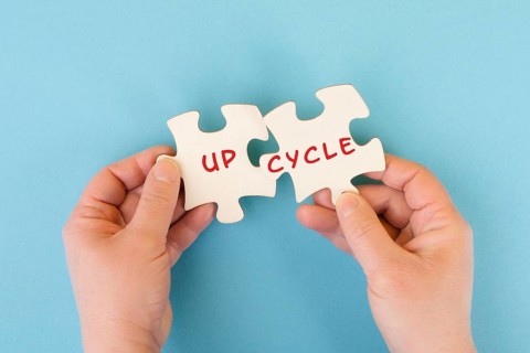 The word up cycle is standing on puzzle pieces, environmental conversation, reuse and repair